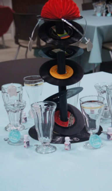 Fallout 4 Wedding Centerpiece A centerpiece of slanted records topped by a red half sphere surrounded by milkshake glasses